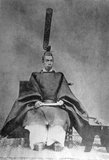 Emperor Meiji (明治天皇 Meiji-tennō, November 3, 1852 – July 30, 1912), or Meiji the Great (明治大帝 Meiji-taitei), was the 122nd Emperor of Japan according to the traditional order of succession, reigning from February 3, 1867 until his death on July 30, 1912. He presided over a time of rapid change in the Empire of Japan, as the nation quickly changed from a feudal state to a capitalist and imperial world power, characterized by Japan's industrial revolution.<br/><br/>

At the time of his birth in 1852, Japan was an isolated, pre-industrial, feudal country dominated by the Tokugawa Shogunate and the daimyo, who ruled over the country's more than 250 decentralized domains. By the time of his death in 1912, Japan had undergone a political, social, and industrial revolution at home and emerged as one of the great powers on the world stage.<br/><br/>

Uchida Kuichi was the only photographer granted a sitting by the Emperor Meiji and in 1872 Uchida photographed the Emperor and Empress Haruko in full court dress and everyday robes. In 1873, Uchida again photographed the Emperor, who this time wore military dress, and a photograph from this sitting became the official imperial portrait.<br/><br/>

Copies of the official portrait were distributed among foreign heads of state and Japanese regional governmental offices, but their private sale was prohibited. Nevertheless, many copies of the photograph were made and circulated on the market. Published in the Japanese book, Meiji Tenno gyoden (Tokyo: 1912).